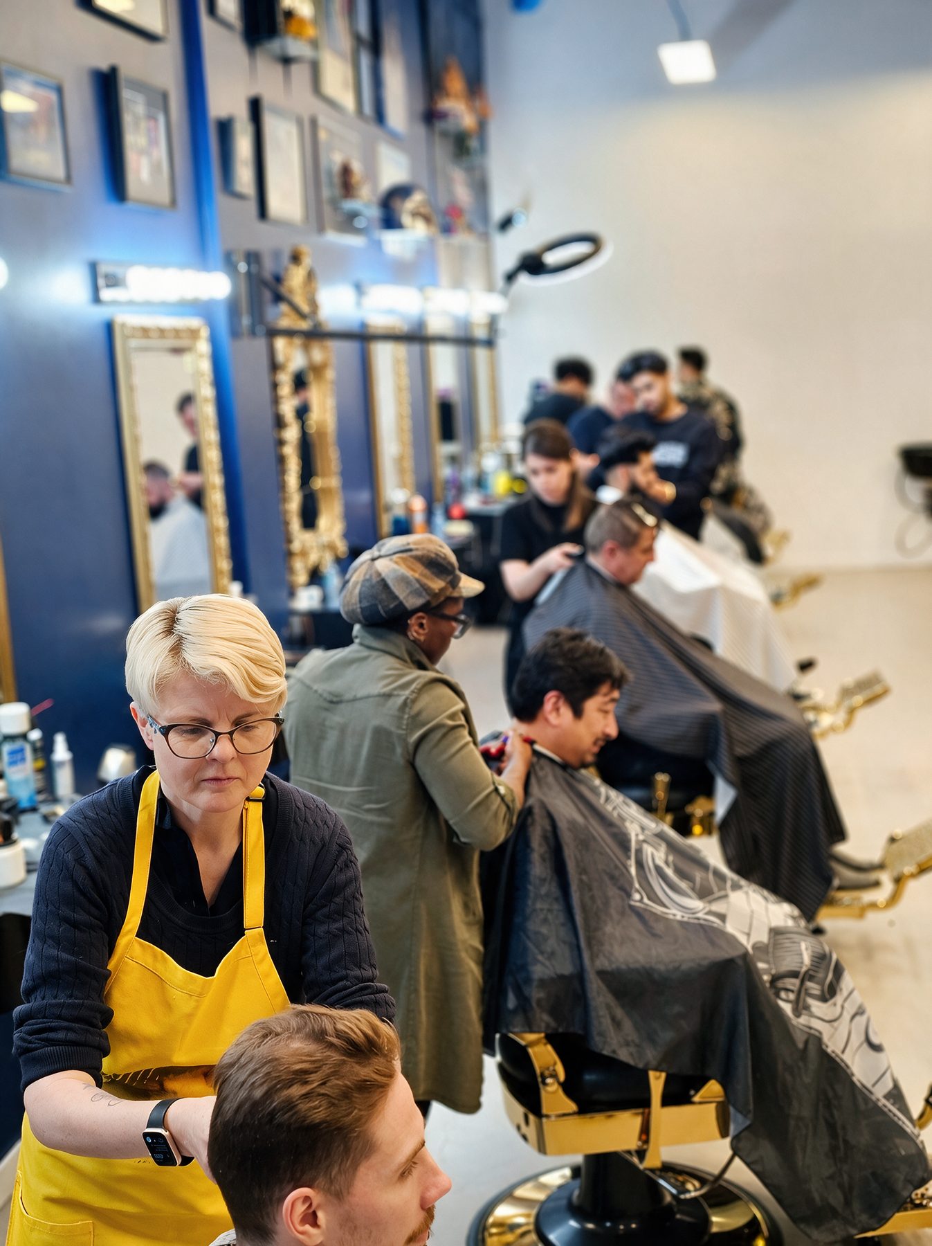 A busy cohort on the Academy floor with an instructor in an apron