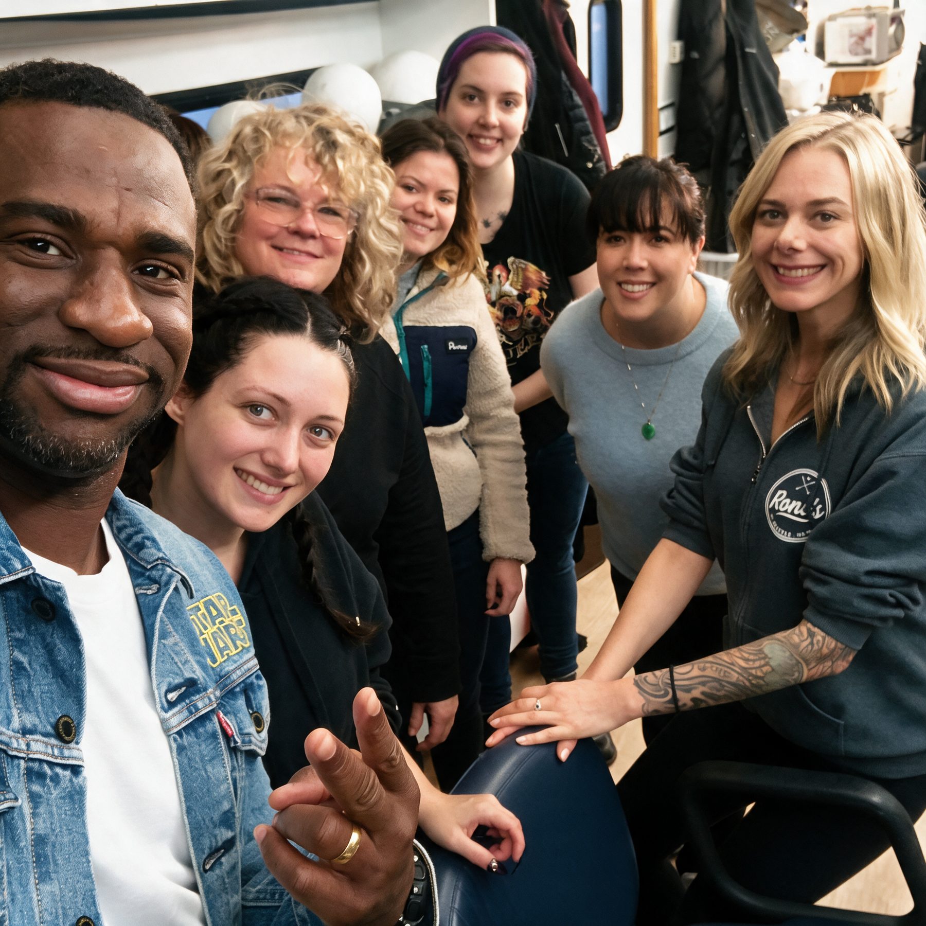 House members and the team together in the shop